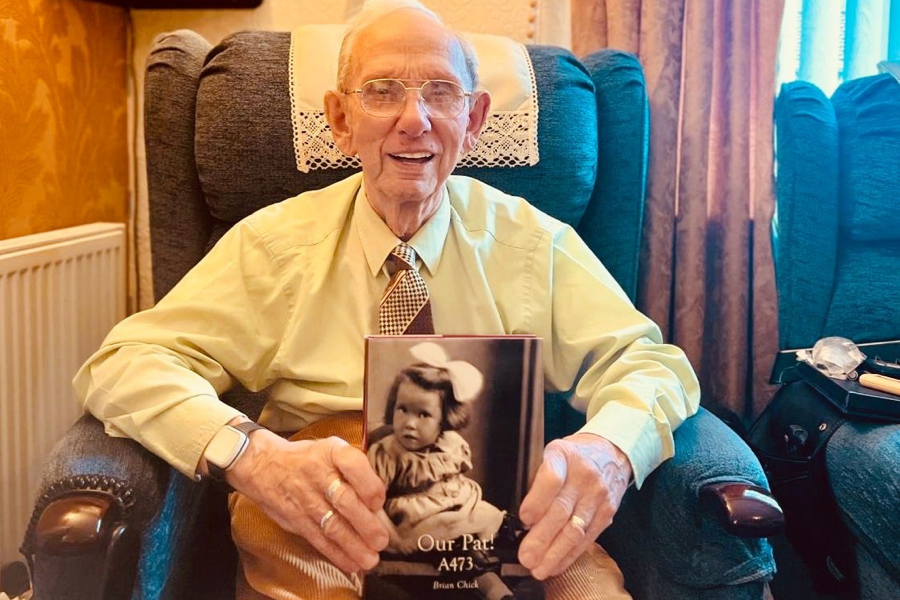 Private autobiography author Brian Chick holding his LifeBook.