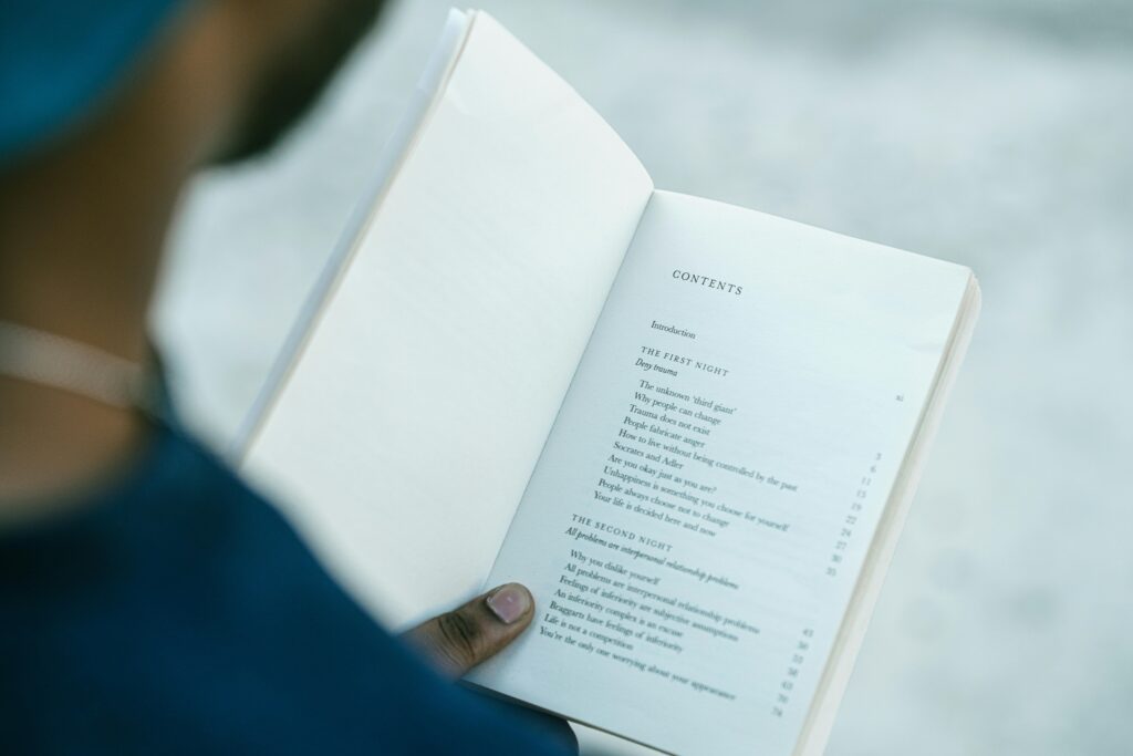 A reader looking at a book's table of contents.