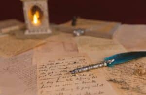 A fountain pen laying on top of assorted pages of notes.