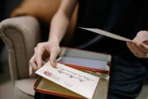 Someone looking through a box of old letters.