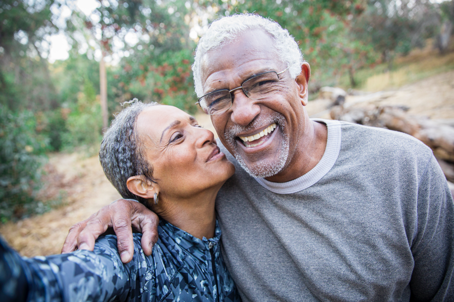 Two people, perhaps a husband and wife or brother and sister, laughing and kissing.