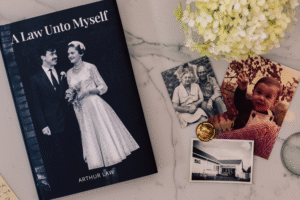 A LifeBook private autobiography entitled A Law Unto Myself by Arthur Law, sitting beside three old family photographs