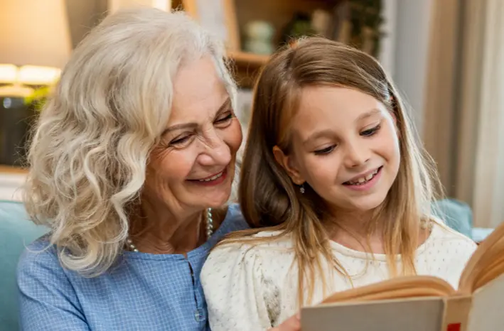 A grandmother showing her grandaughter her memoir