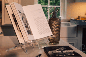 A photograph of a book propped open on a display stand.