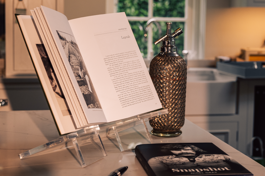 A photograph of a book propped open on a display stand.