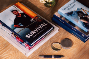 Several private autobiographies on a tabletop with other assorted items.