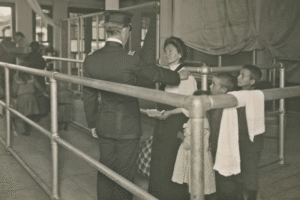 Immigrants to the USA facing a uniformed official.