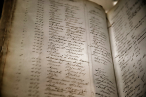 A photograph of an hold handwritten record book.