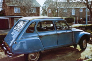 A photograph of an old blue Citroen 2CV